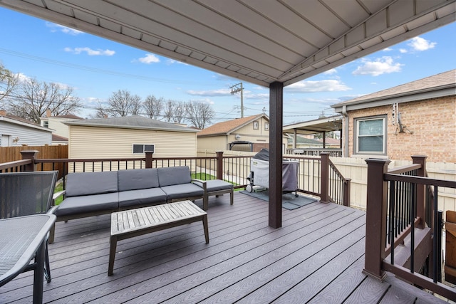 wooden terrace with outdoor lounge area, fence, and a residential view