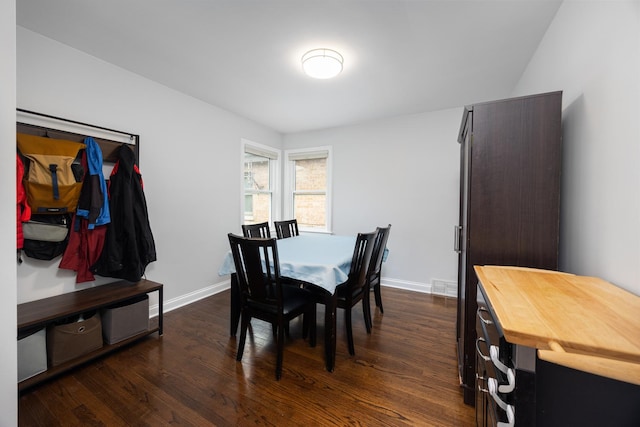 dining area with baseboards and dark wood-style floors
