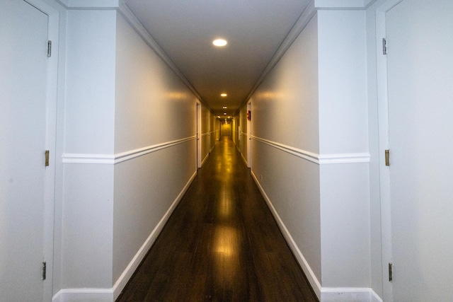 hallway featuring wood finished floors, recessed lighting, and baseboards