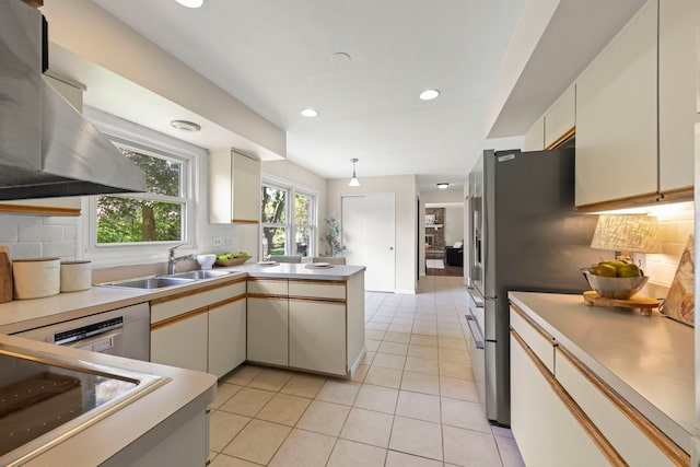 542 Stafford Ln, Glen Ellyn, IL 60137 - kitchen featuring a sink, a peninsula, light tile patterned floors, tasteful backsplash, and wall chimney range hood