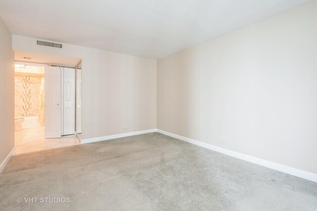 hallway with an inviting chandelier, baseboards, and light tile patterned flooring
