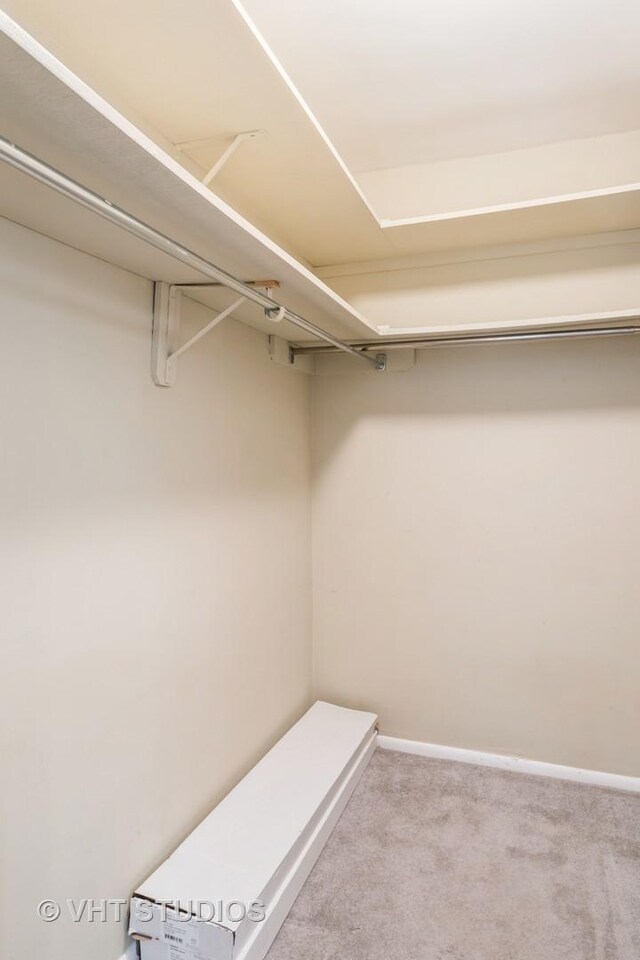 carpeted spare room featuring visible vents and baseboards