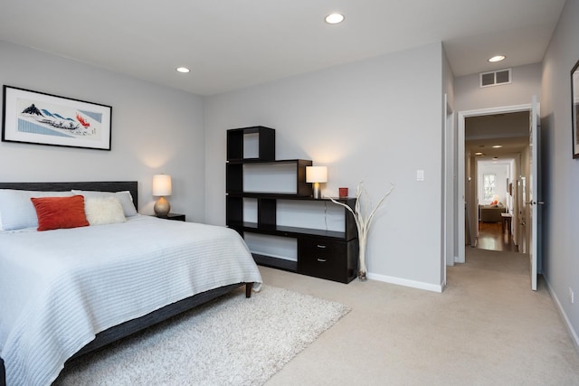 bedroom featuring baseboards, light colored carpet, recessed lighting, and visible vents