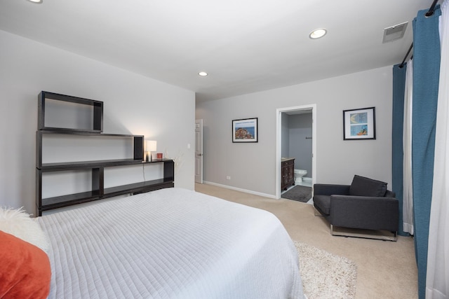 bedroom featuring visible vents, baseboards, light colored carpet, recessed lighting, and ensuite bath
