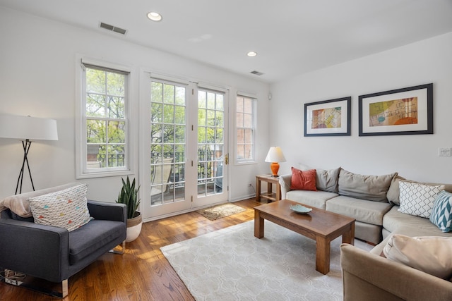 living room with visible vents, recessed lighting, plenty of natural light, and wood finished floors