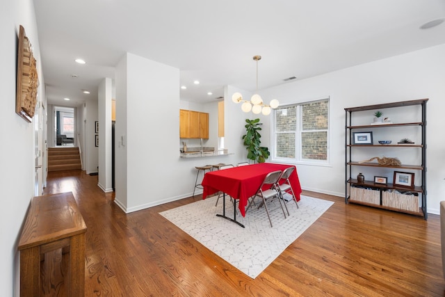 dining space with stairs, recessed lighting, baseboards, and wood finished floors