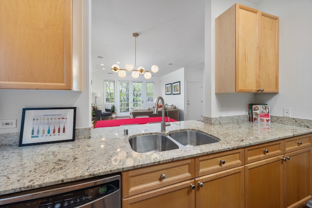 kitchen with a sink, light stone counters, an inviting chandelier, and dishwasher