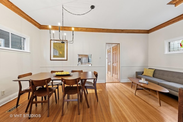 309 Wesley Ave, Oak Park, IL 60302 - dining area featuring a chandelier, baseboards, light wood-style floors, and crown molding