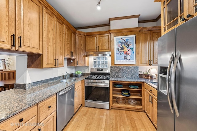 309 Wesley Ave, Oak Park, IL 60302 - kitchen with light wood finished floors, a sink, under cabinet range hood, ornamental molding, and appliances with stainless steel finishes