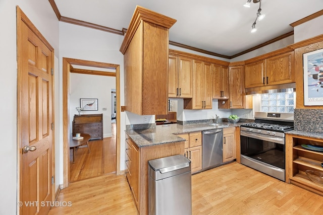 309 Wesley Ave, Oak Park, IL 60302 - kitchen featuring dark stone counters, stainless steel appliances, a sink, light wood-type flooring, and crown molding