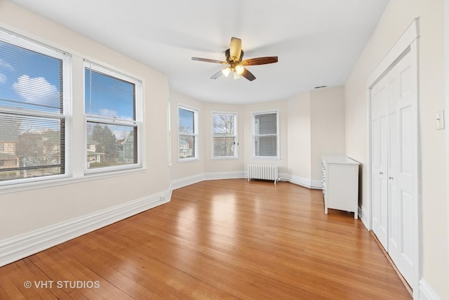 309 Wesley Ave, Oak Park, IL 60302 - unfurnished bedroom featuring radiator heating unit, multiple windows, and light wood-style flooring
