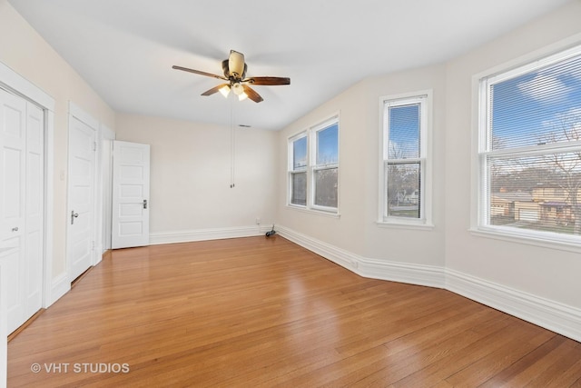309 Wesley Ave, Oak Park, IL 60302 - unfurnished bedroom featuring multiple windows, ceiling fan, light wood-type flooring, and baseboards