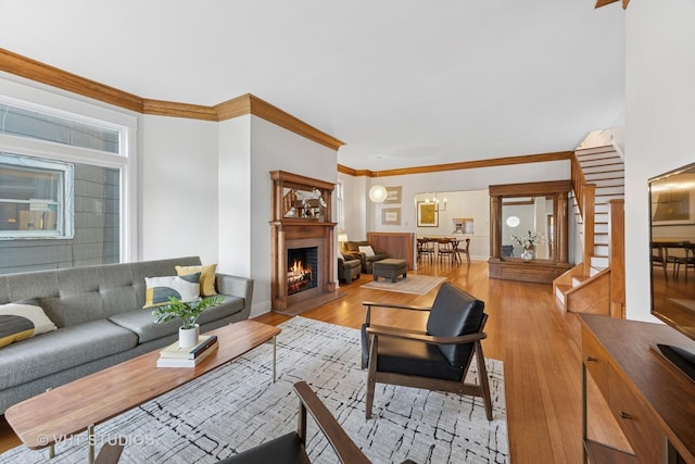 309 Wesley Ave, Oak Park, IL 60302 - living room featuring baseboards, wood finished floors, ornamental molding, and a warm lit fireplace