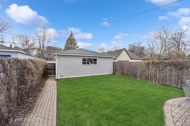 309 Wesley Ave, Oak Park, IL 60302 - rear view of house with a fenced backyard, a yard, and roof with shingles