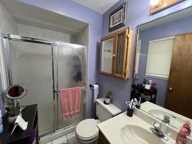 full bathroom featuring toilet, a shower stall, and vanity