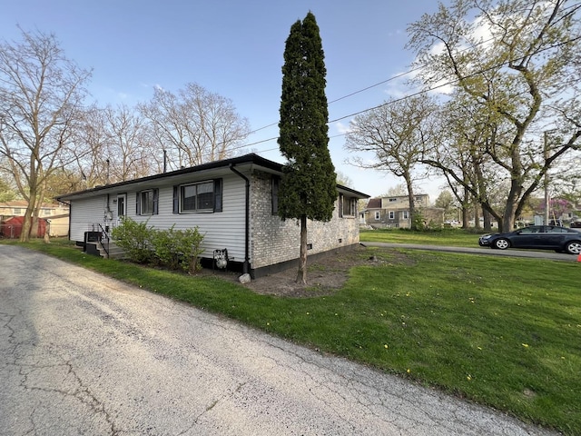 view of property exterior with a yard