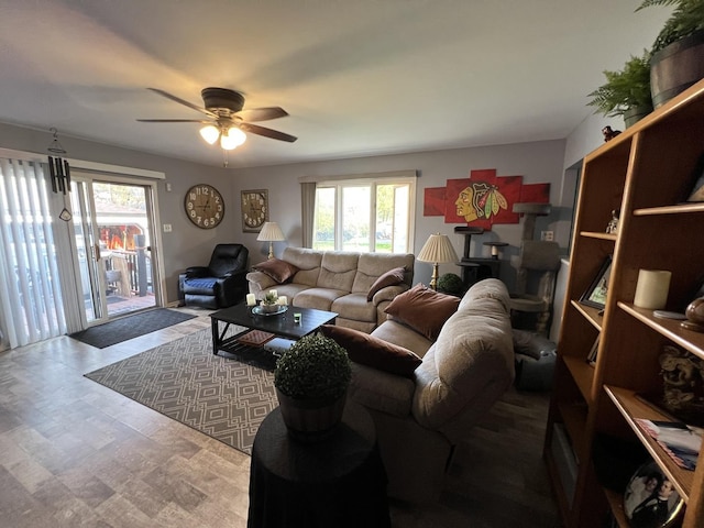 living room featuring ceiling fan and a wealth of natural light