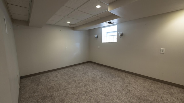 below grade area featuring recessed lighting, carpet, baseboards, visible vents, and a paneled ceiling