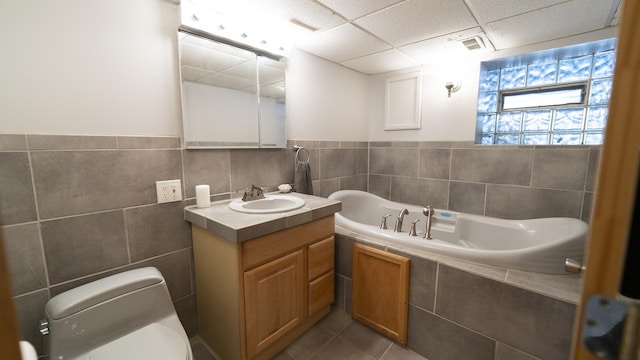 bathroom with tile patterned flooring, toilet, vanity, visible vents, and a garden tub