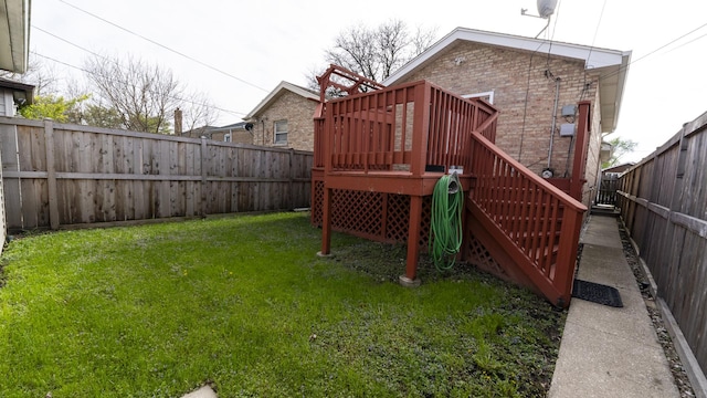 view of yard featuring stairs, a wooden deck, and a fenced backyard