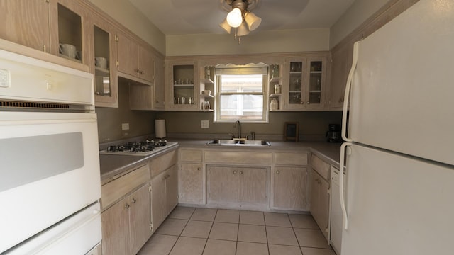 kitchen featuring light tile patterned floors, a sink, ceiling fan, a warming drawer, and white appliances
