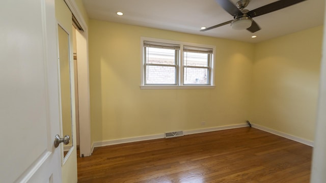 unfurnished room featuring visible vents, wood finished floors, and baseboards