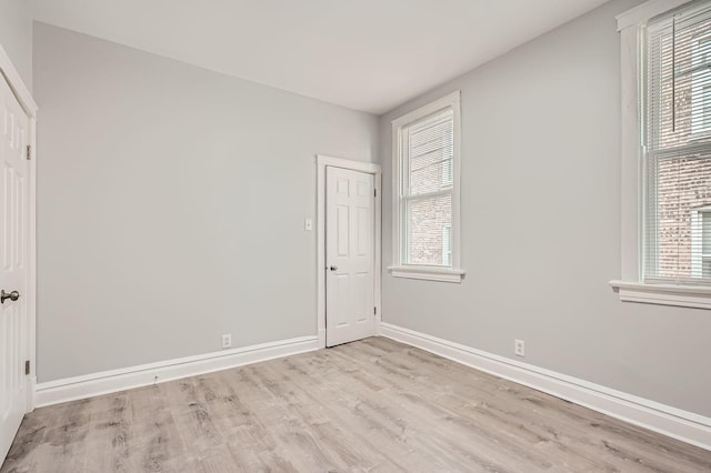 unfurnished room featuring wood finished floors and baseboards