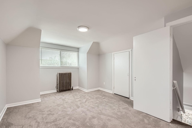 additional living space featuring baseboards, radiator heating unit, and carpet