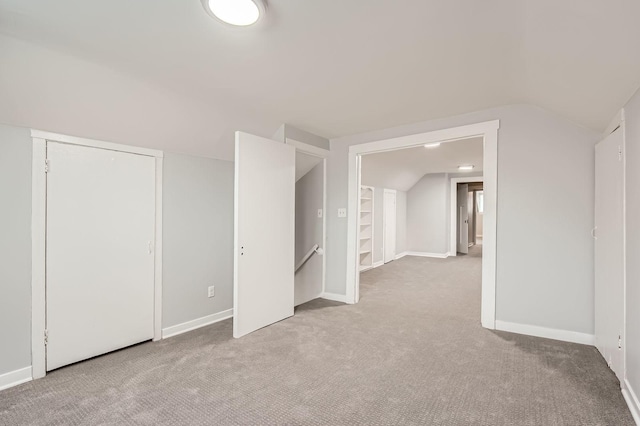 bonus room featuring vaulted ceiling, carpet floors, and baseboards
