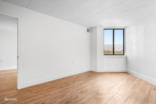 1750 N Marywood Ave Unit 501, Aurora, IL 60505 - unfurnished room with a textured ceiling, wood finished floors, and baseboards
