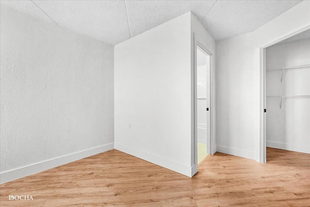 1750 N Marywood Ave Unit 501, Aurora, IL 60505 - interior space featuring baseboards, light wood-style floors, a closet, and a textured ceiling