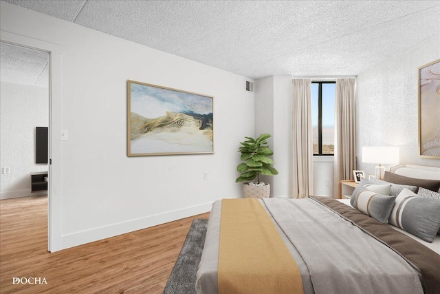 1750 N Marywood Ave Unit 501, Aurora, IL 60505 - bedroom with a textured ceiling, baseboards, light wood-type flooring, and visible vents