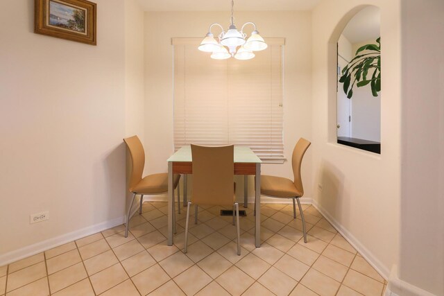 4566 Concord Ln, Northbrook, IL 60062 - dining space featuring a chandelier, light tile patterned floors, baseboards, and arched walkways