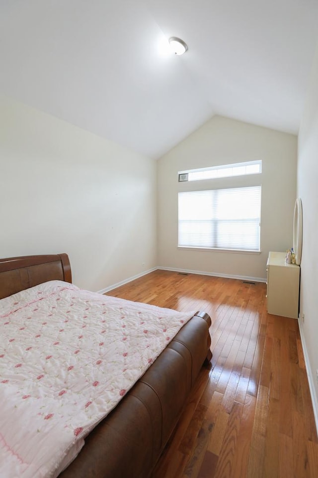 4566 Concord Ln, Northbrook, IL 60062 - bedroom with hardwood / wood-style flooring, vaulted ceiling, and baseboards