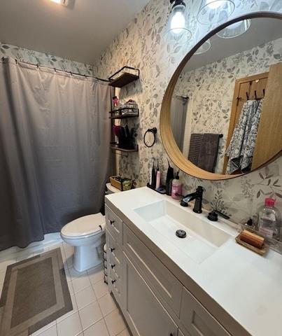 full bathroom with a shower with curtain, wallpapered walls, toilet, vanity, and tile patterned flooring