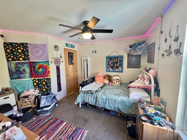 bedroom featuring visible vents, a ceiling fan, and carpet floors