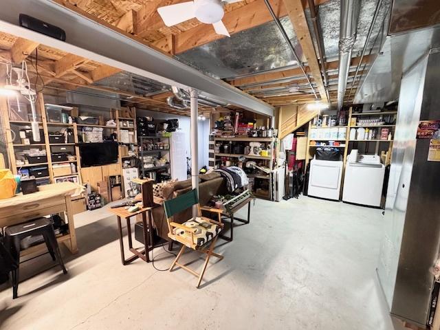 unfinished below grade area featuring independent washer and dryer