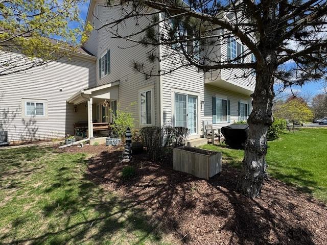 rear view of property with a lawn