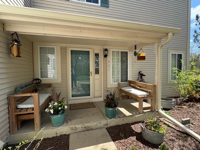 view of exterior entry with covered porch
