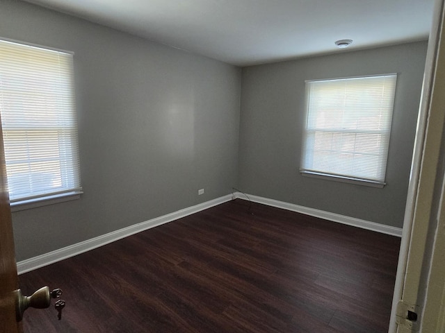 15016 S Holiday Ct, Orland Park, IL 60462 - empty room featuring plenty of natural light, dark wood-style flooring, and baseboards