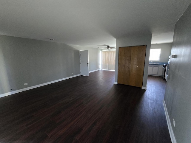 15016 S Holiday Ct, Orland Park, IL 60462 - unfurnished living room featuring dark wood-style flooring, ceiling fan, and baseboards