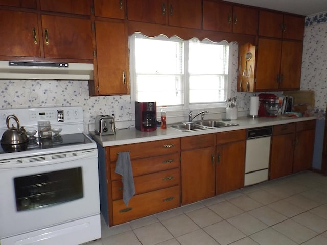 kitchen featuring a sink, light countertops, white electric stove, and under cabinet range hood