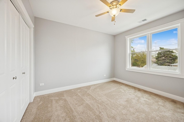 3141 Harvey Ave, Berwyn, IL 60402 - unfurnished bedroom featuring ceiling fan, light colored carpet, baseboards, visible vents, and a closet