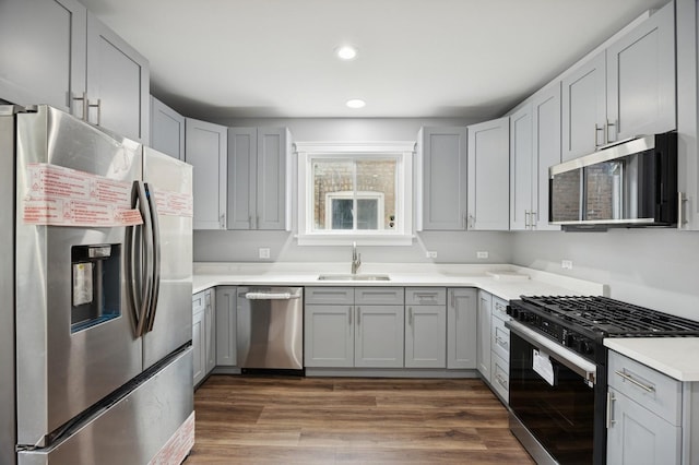 3141 Harvey Ave, Berwyn, IL 60402 - kitchen featuring appliances with stainless steel finishes, a sink, light countertops, recessed lighting, and gray cabinetry