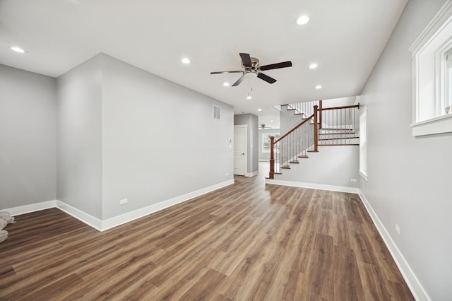 3141 Harvey Ave, Berwyn, IL 60402 - unfurnished living room with a ceiling fan, visible vents, wood finished floors, stairway, and baseboards