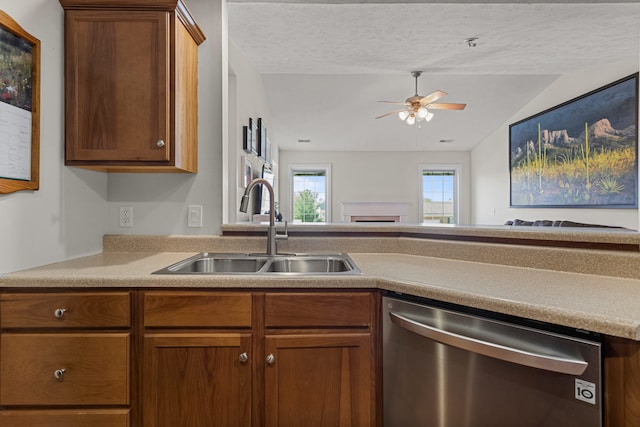 kitchen featuring ceiling fan, light countertops, a sink, dishwasher, and vaulted ceiling