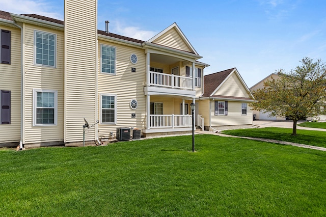 exterior space with central AC, a balcony, a chimney, a lawn, and a porch