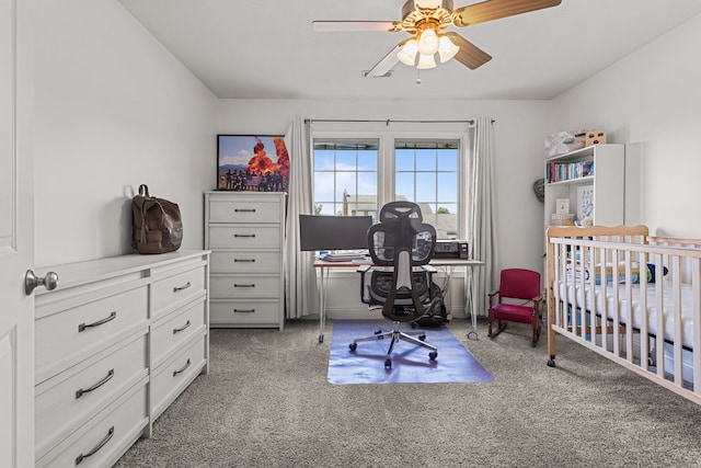 bedroom with a nursery area, light carpet, and a ceiling fan