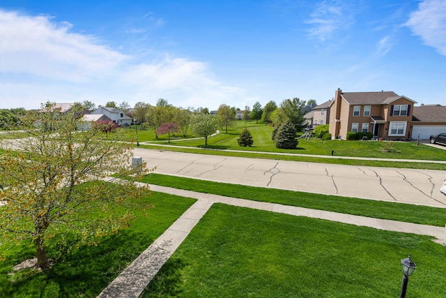 exterior space with street lighting, sidewalks, and a residential view