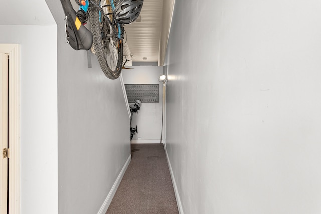 hall with baseboards and carpet flooring